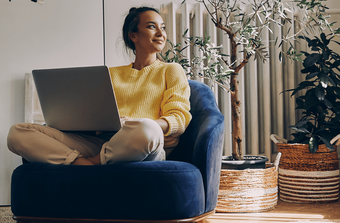 Young adult woman who is a volunteer with Crisis Text Line sitting at her computer.